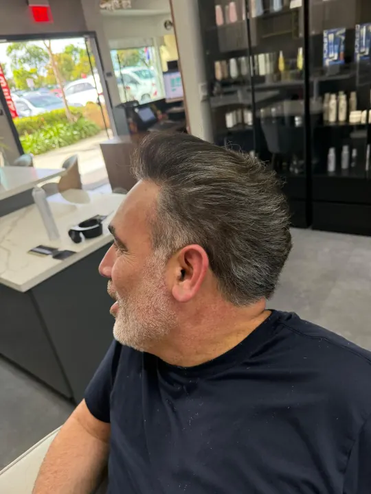 A barber shaping a client’s haircut